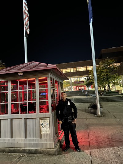 Public Safety Officer by the campus entrance at night
